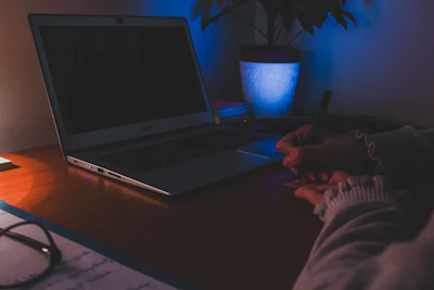 a laptop computer sitting on top of a wooden desk