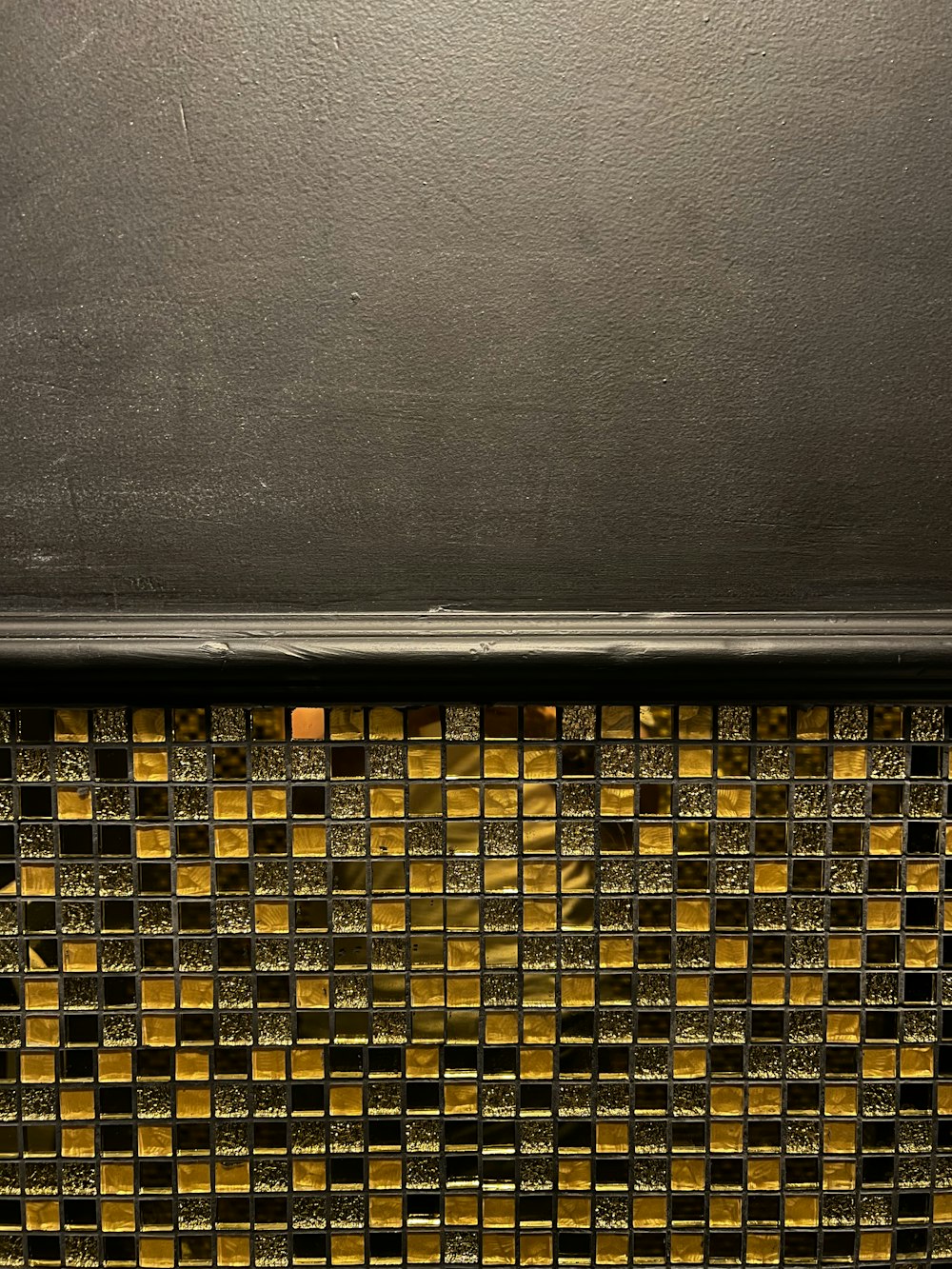 a close up of a wall with a yellow and black pattern