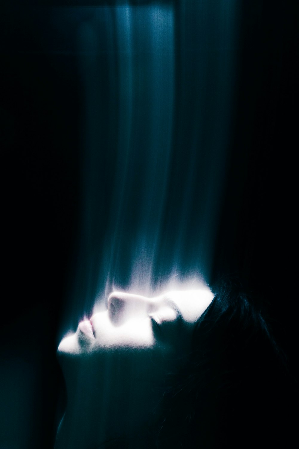 a blurry image of a woman's face in the dark