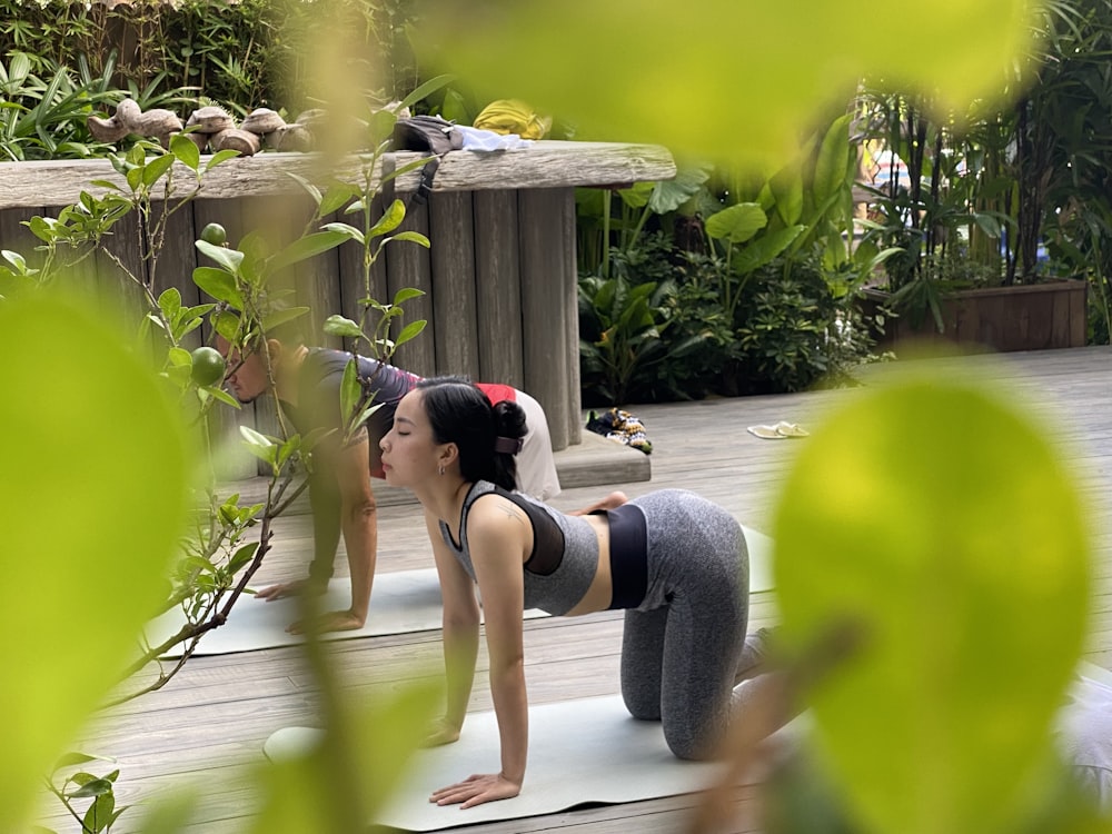 a woman is doing a yoga pose on a mat