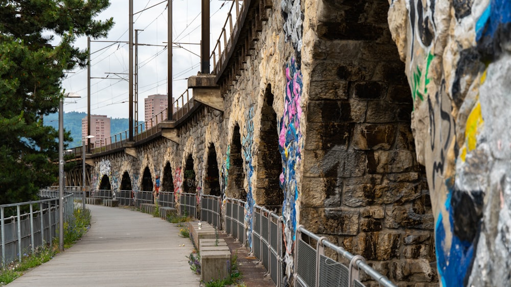 a walkway with graffiti on the side of it