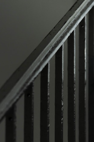 Close-up of a sturdy metal handrail with a matte black finish.