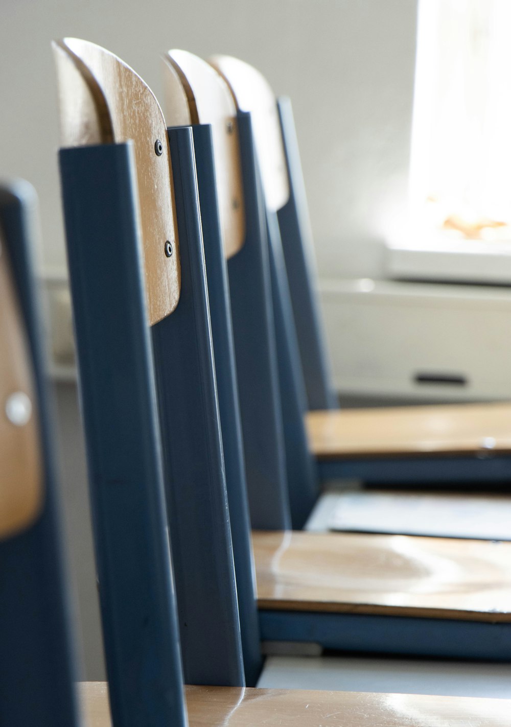 a row of wooden chairs sitting next to each other