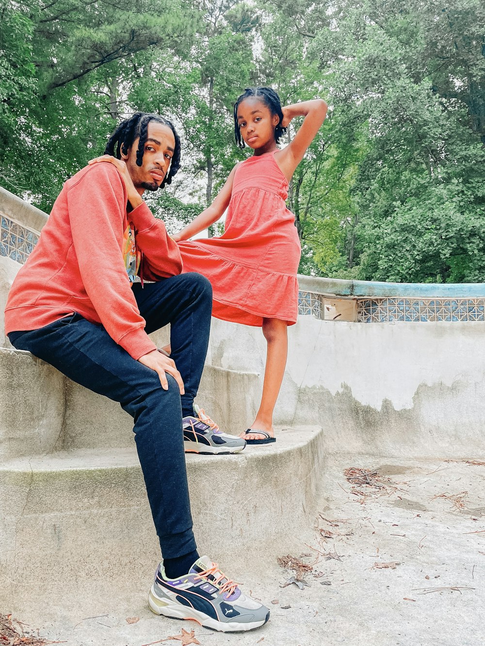 a man and a woman sitting on a cement step