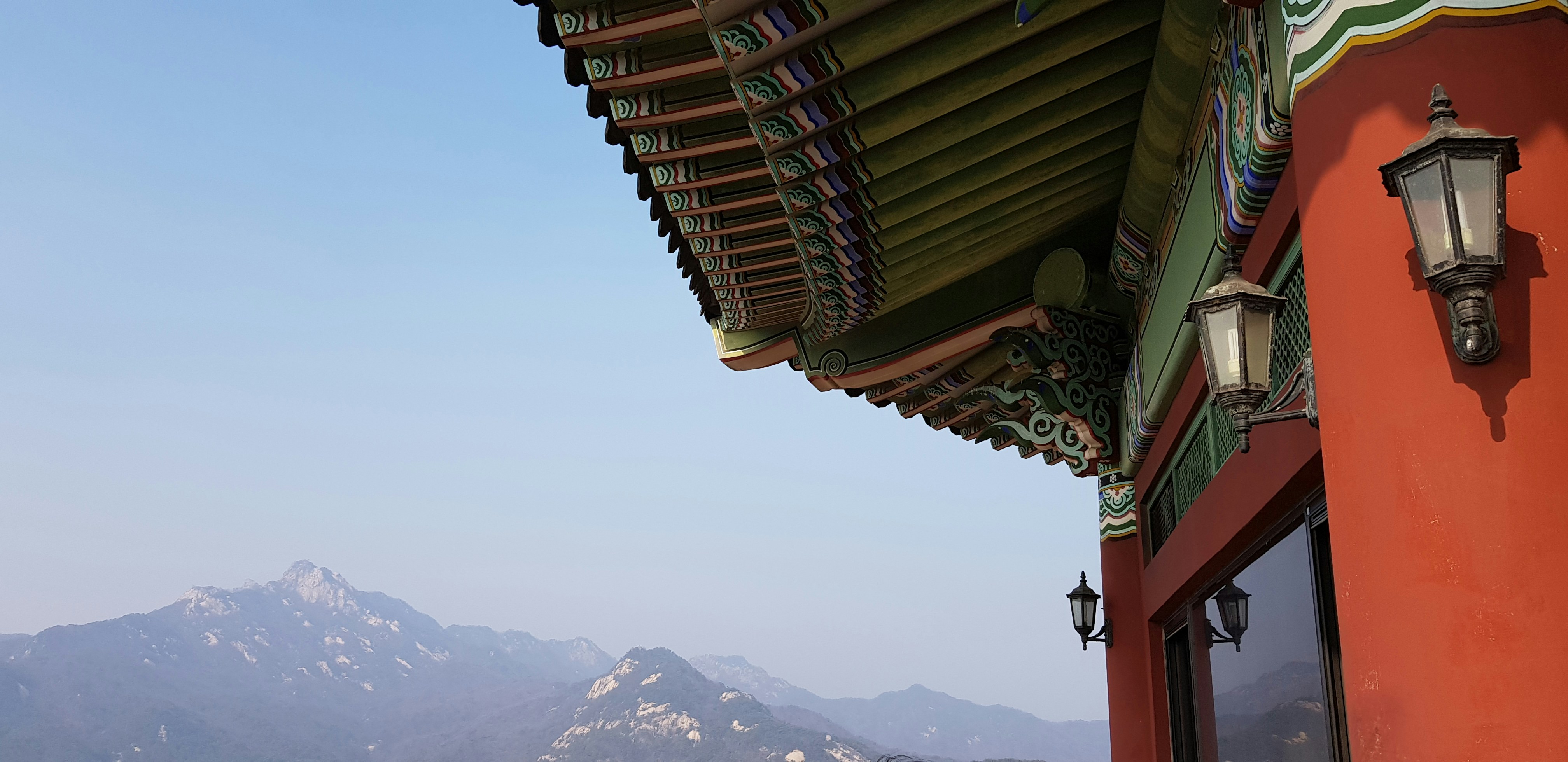 a red building with a mountain in the background