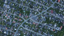 An aerial view of diverse residential properties in a suburban neighborhood.