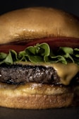 Close-up of a classic cheeseburger with melted cheese and fresh lettuce.