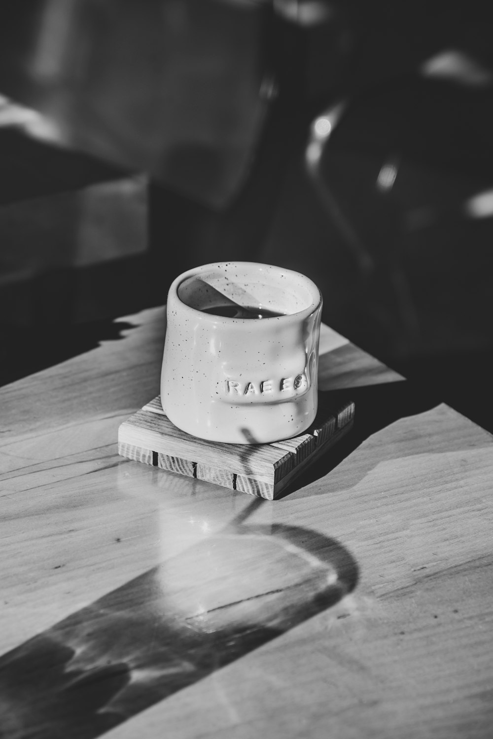 a white cup sitting on top of a wooden table