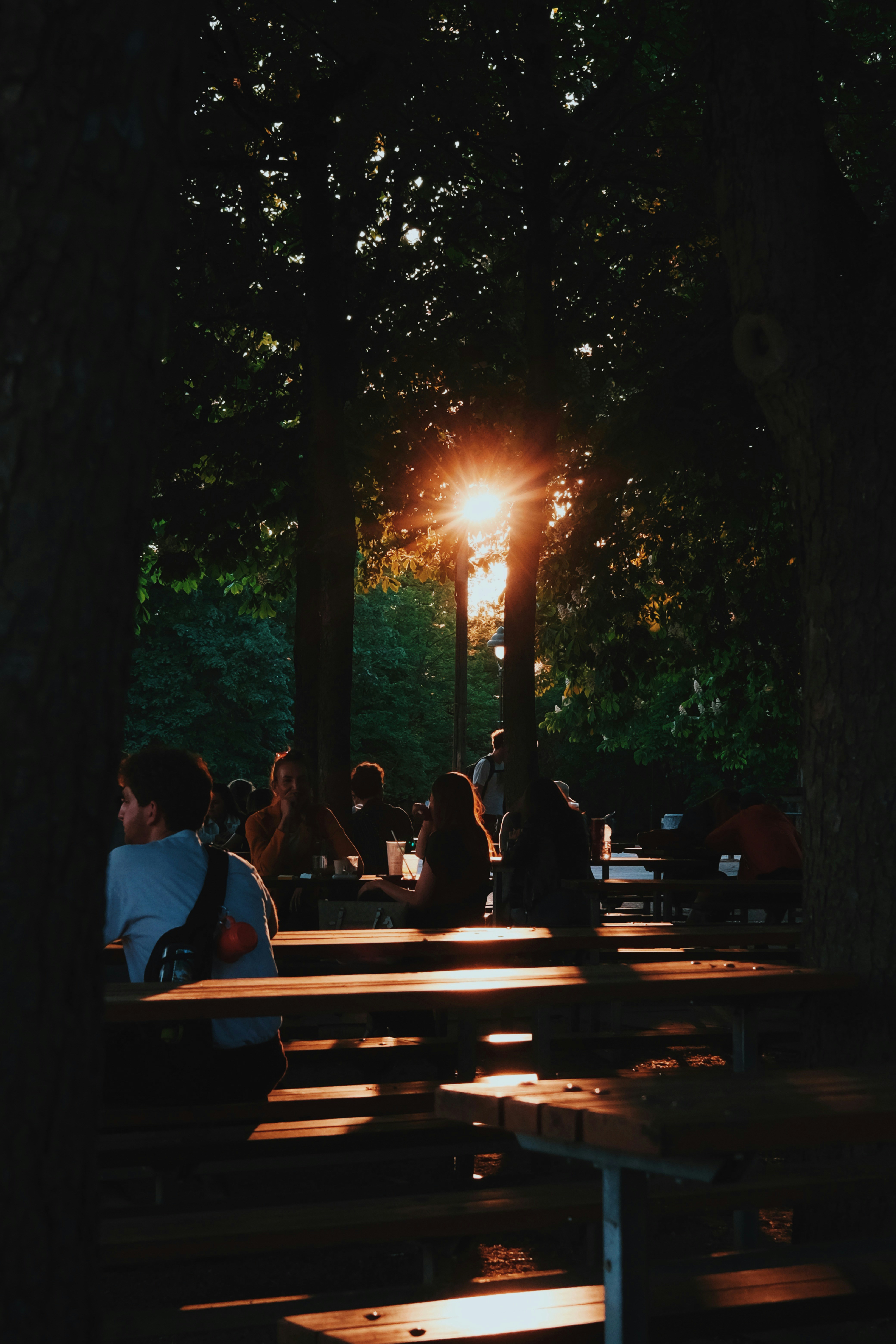 a group of people sitting on top of wooden benches
