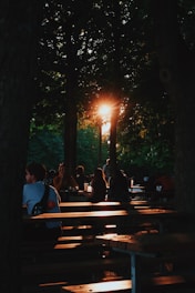a group of people sitting on top of wooden benches