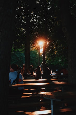 a group of people sitting on top of wooden benches