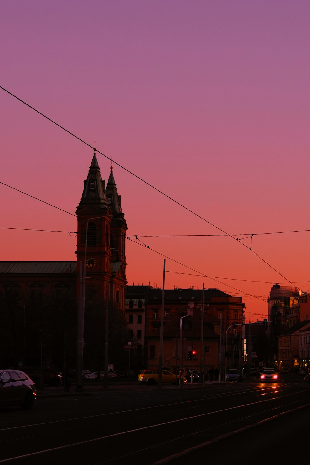 a city street with a clock tower in the background