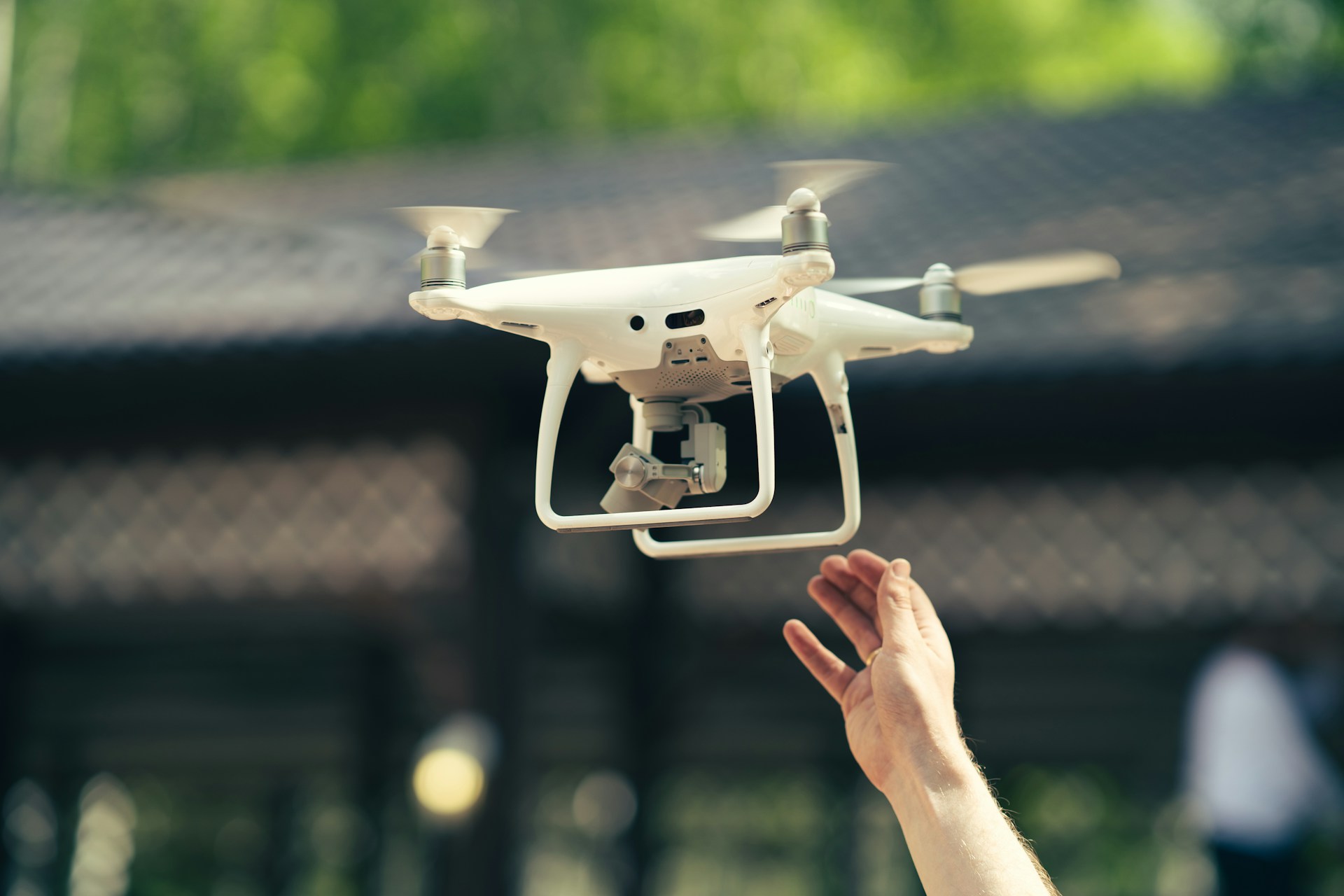 a person holding up a small white object in the air