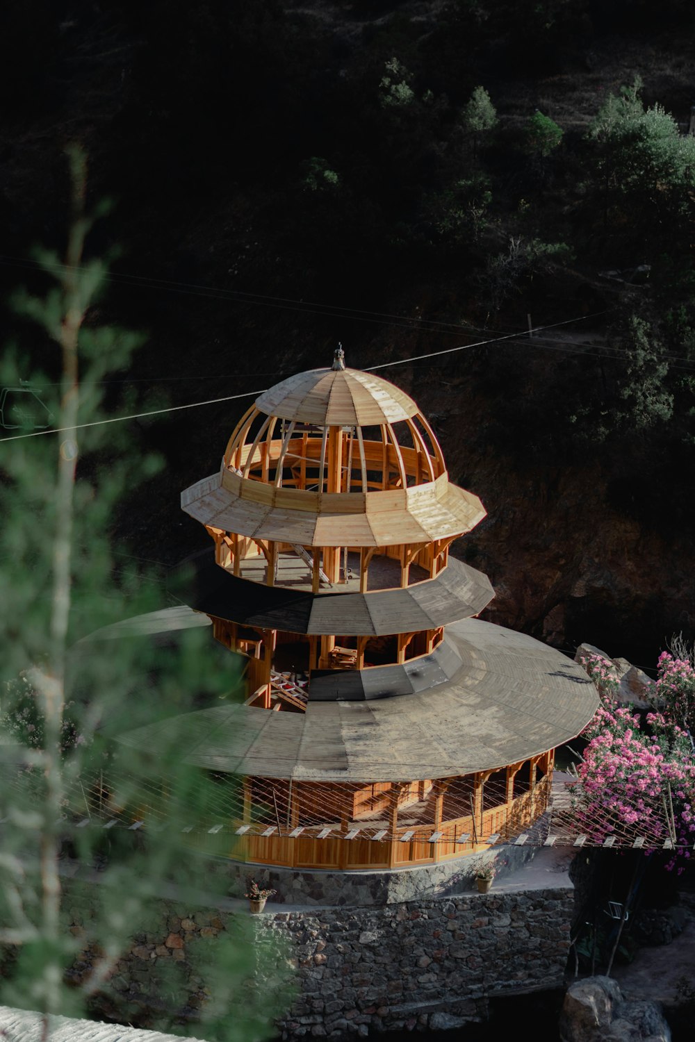 a building made of wood sitting on top of a hill