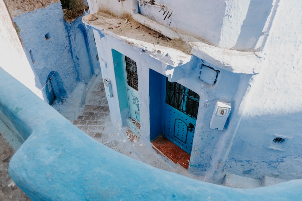 an aerial view of a blue building with a blue door