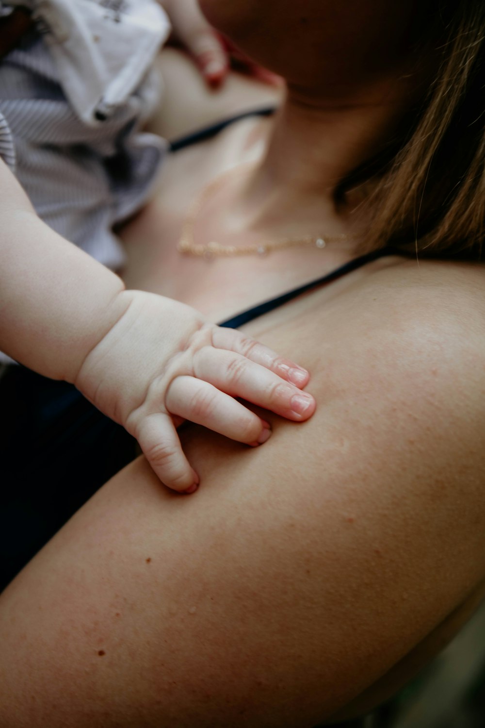 a woman holding a baby in her arms