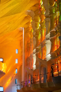 The intricate details of La Sagrada Familia’s interior, bathed in colorful light from stained glass windows.