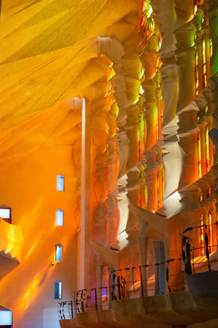 The intricate details of La Sagrada Familia’s interior, bathed in colorful light from stained glass windows.