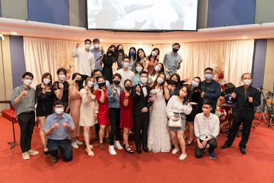 Team of cleaners wearing masks and gloves, standing proudly in front of a freshly cleaned lobby.