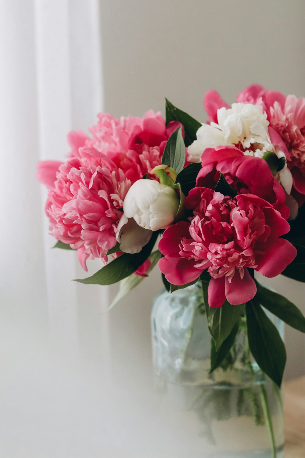 a vase filled with pink and white flowers