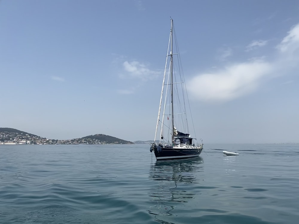 a sailboat in the middle of a body of water