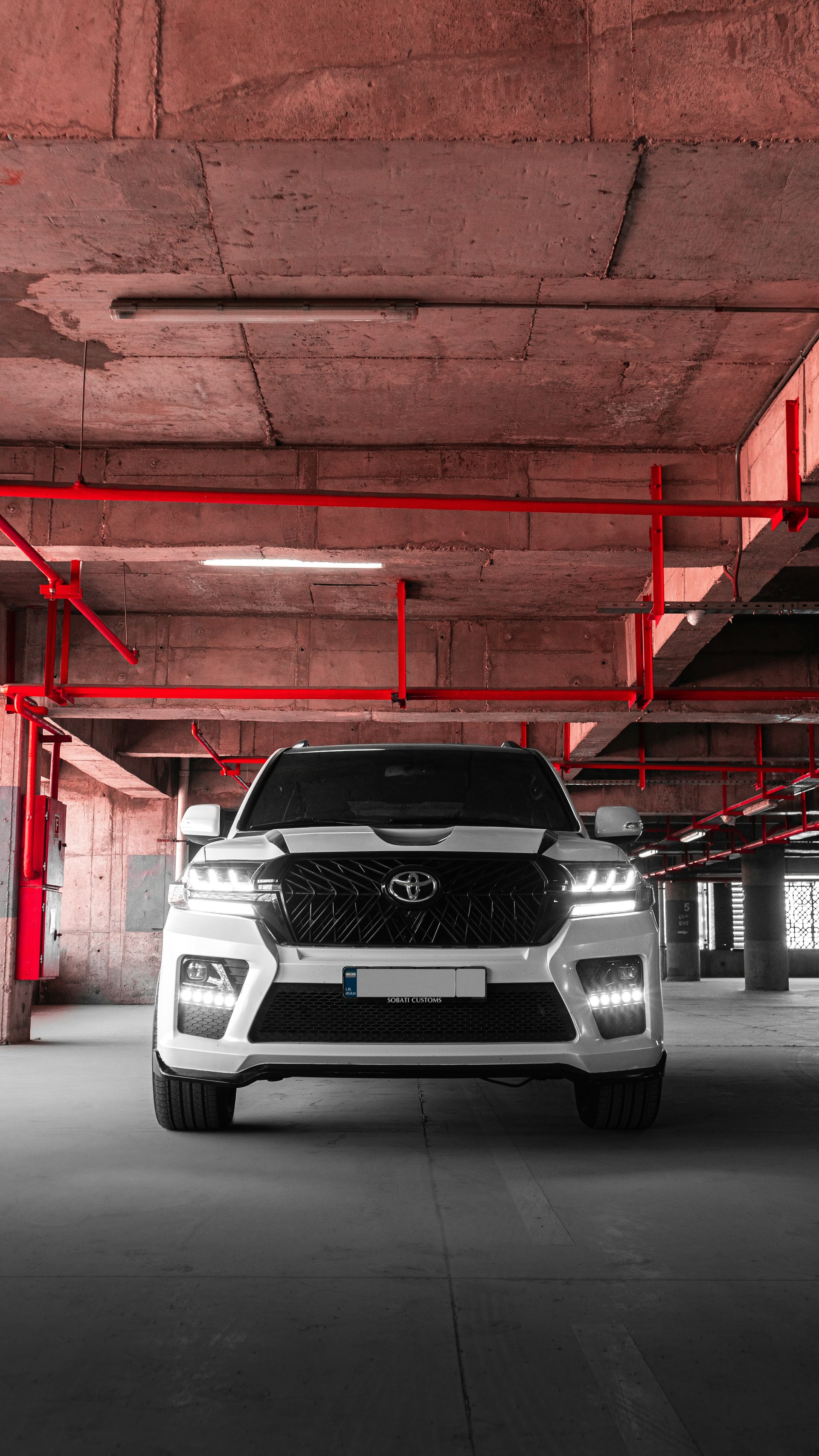 a white suv parked in a parking garage