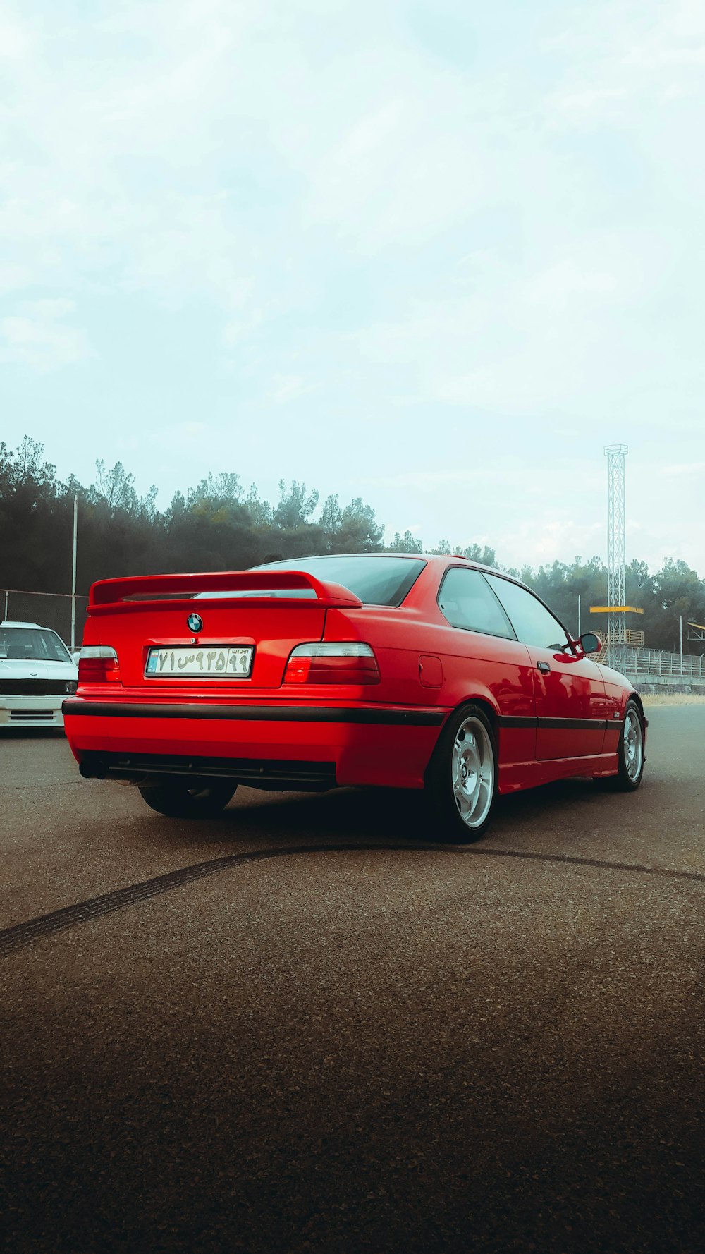 a red car is parked in a parking lot