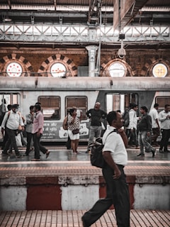 The bustling Philadelphia 30th Street Station platform filled with travelers and city skyline in the background.