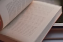 Close-up of an open book with elegant serif typography, softly lit by natural light.