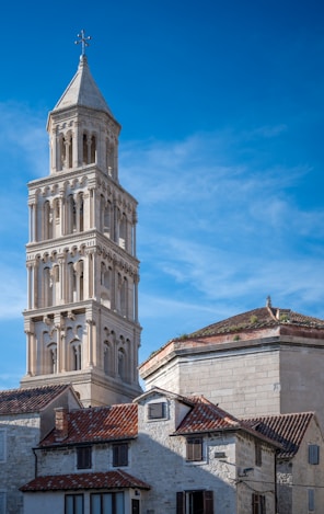 a tall tower with a cross on top of it