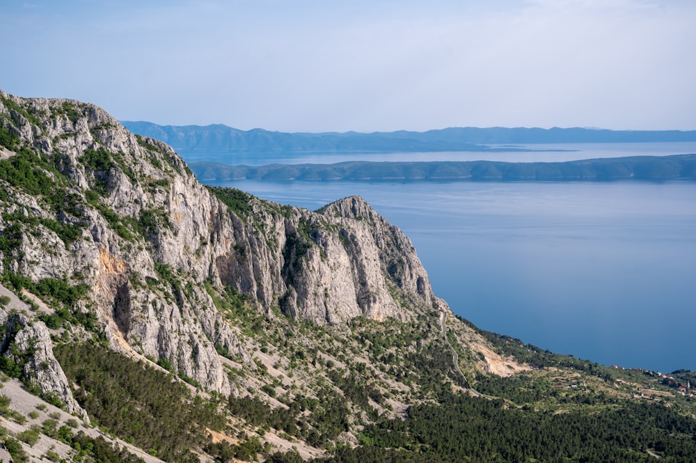 a view of a mountain with a body of water in the distance