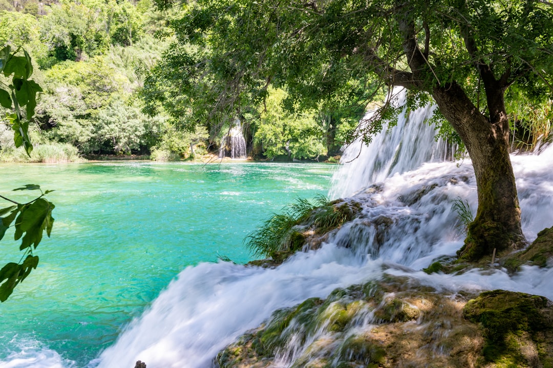 a small waterfall in the middle of a river,
