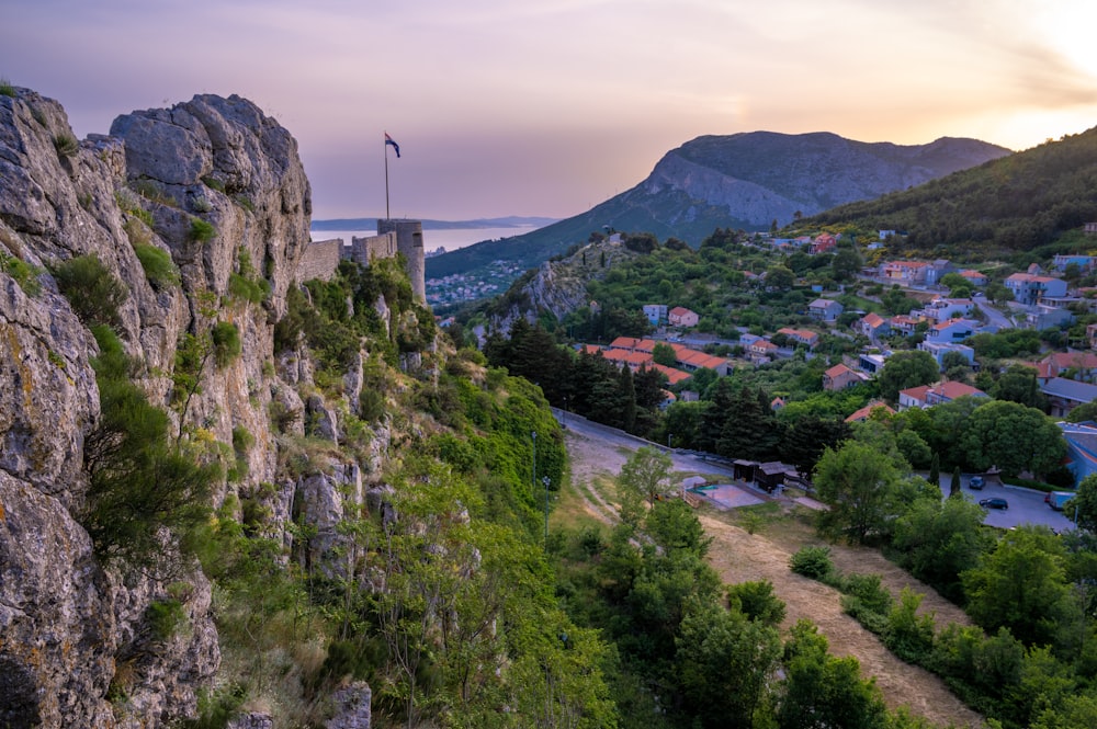 a scenic view of a small town on the side of a mountain