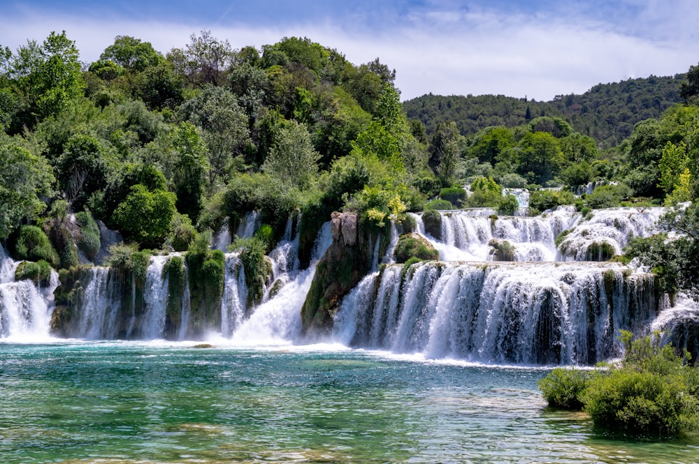 a large waterfall in the middle of a river