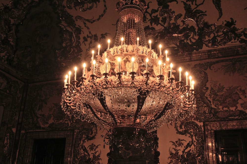 a chandelier with many lit candles hanging from it