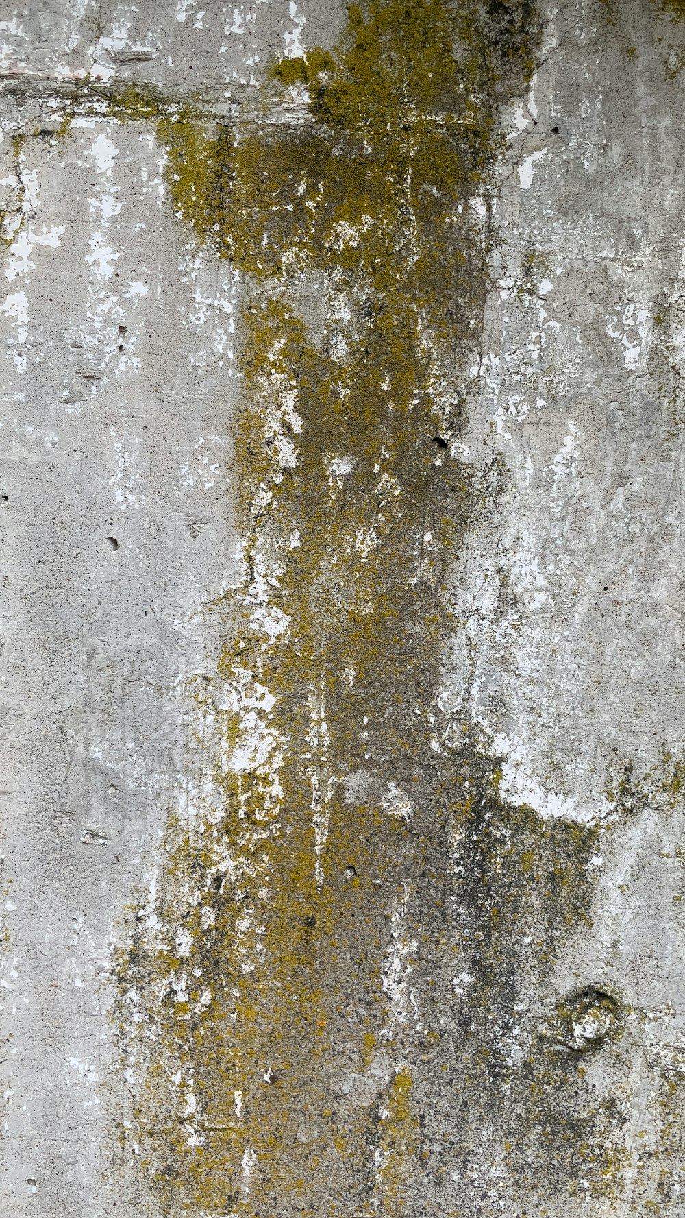 an old wall with yellow and white paint