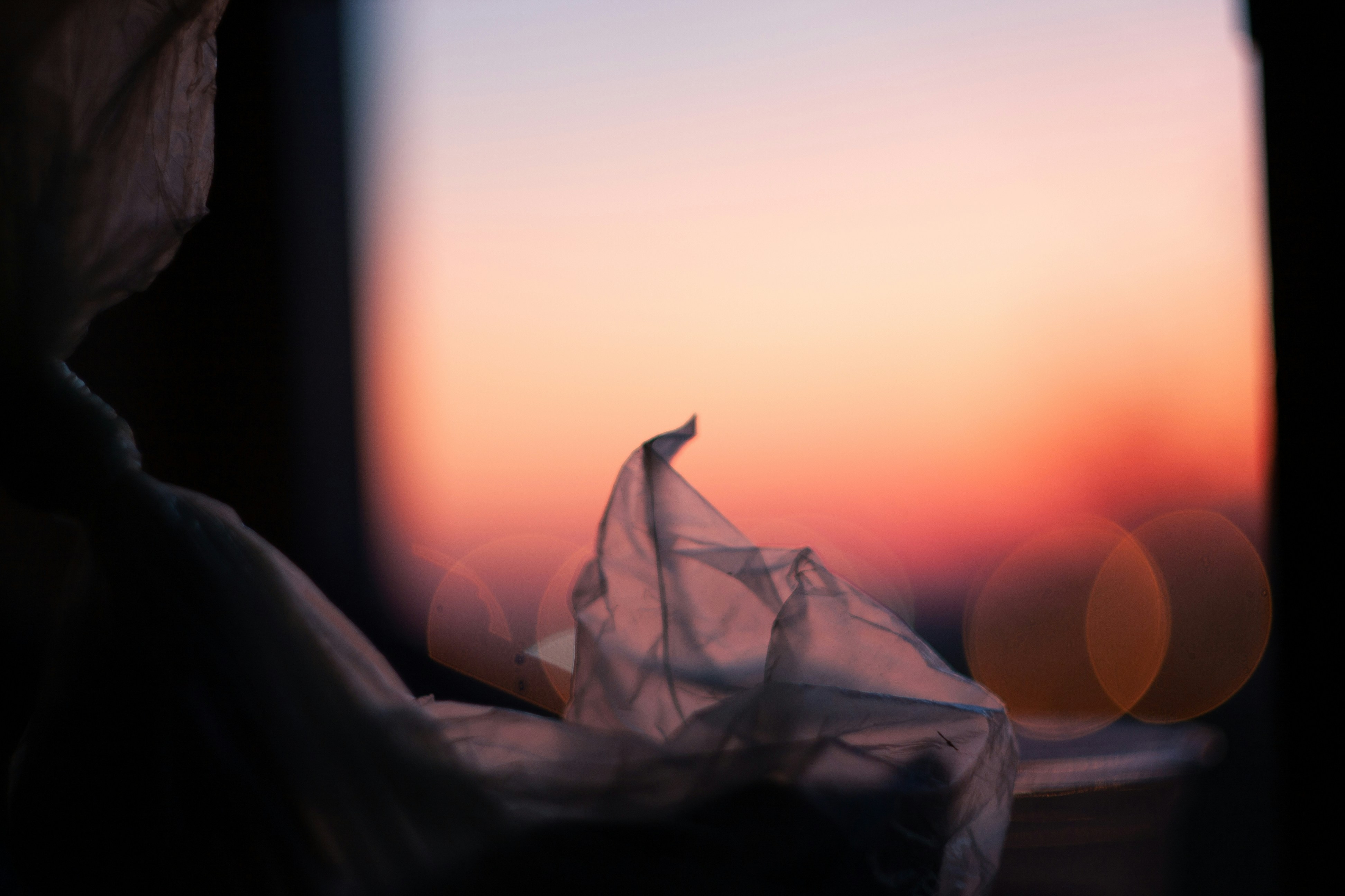 a blurry photo of a piece of cloth in front of a window
