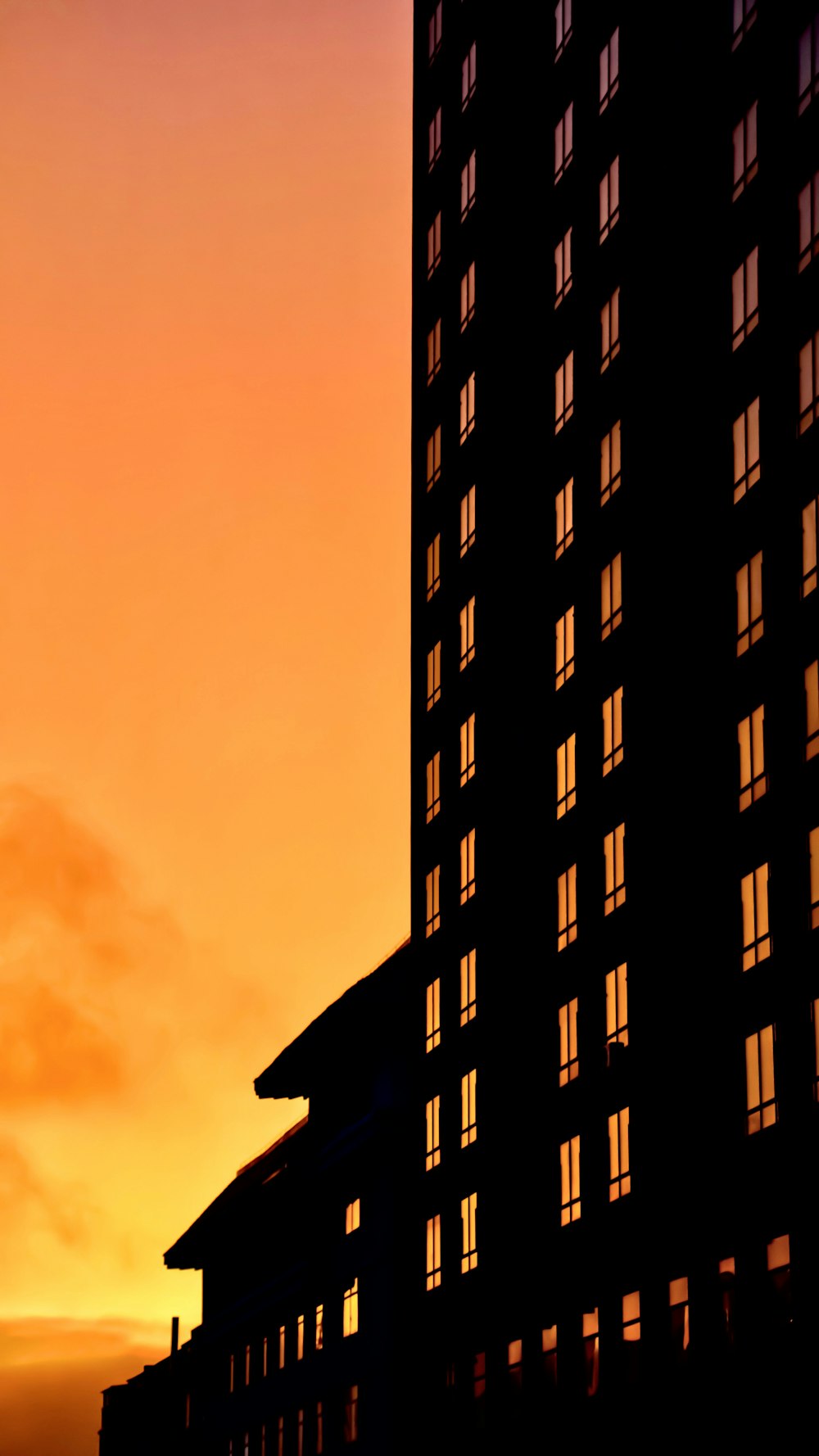 a tall building sitting next to a very tall building