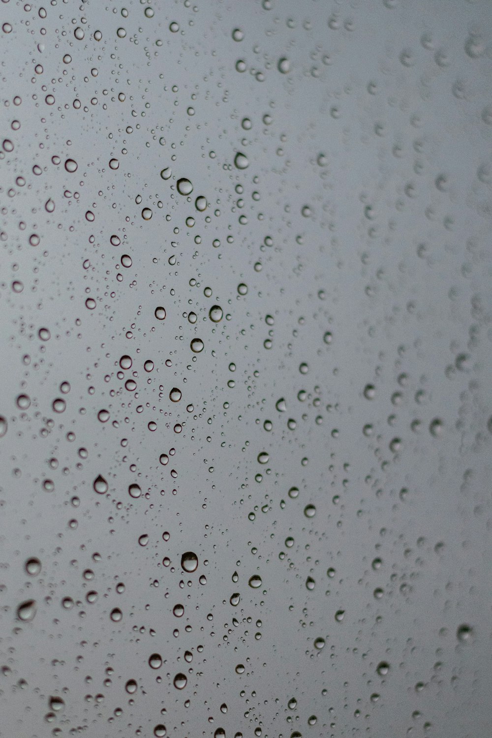 rain drops on a window with a sky background
