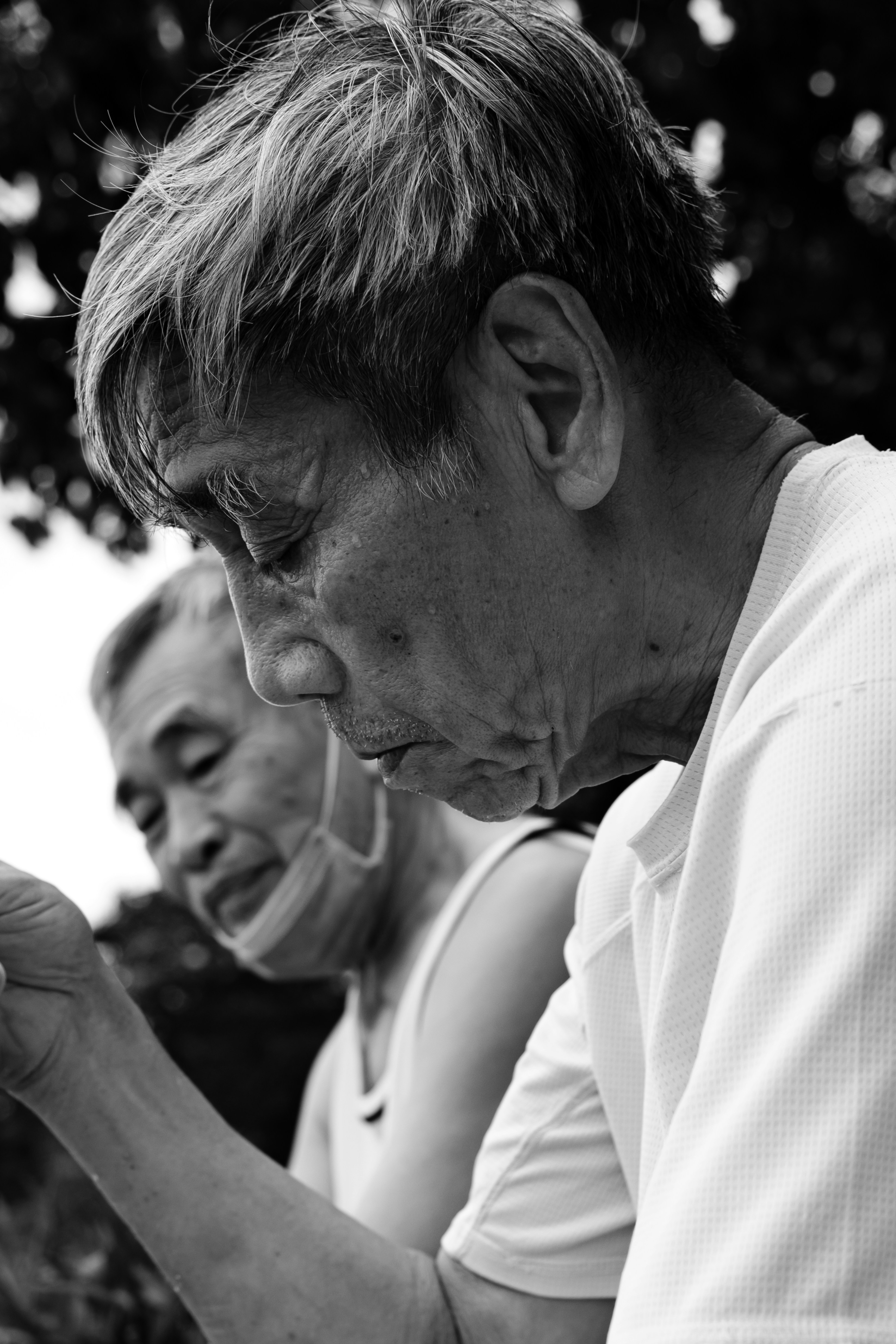 a black and white photo of a man holding a cell phone