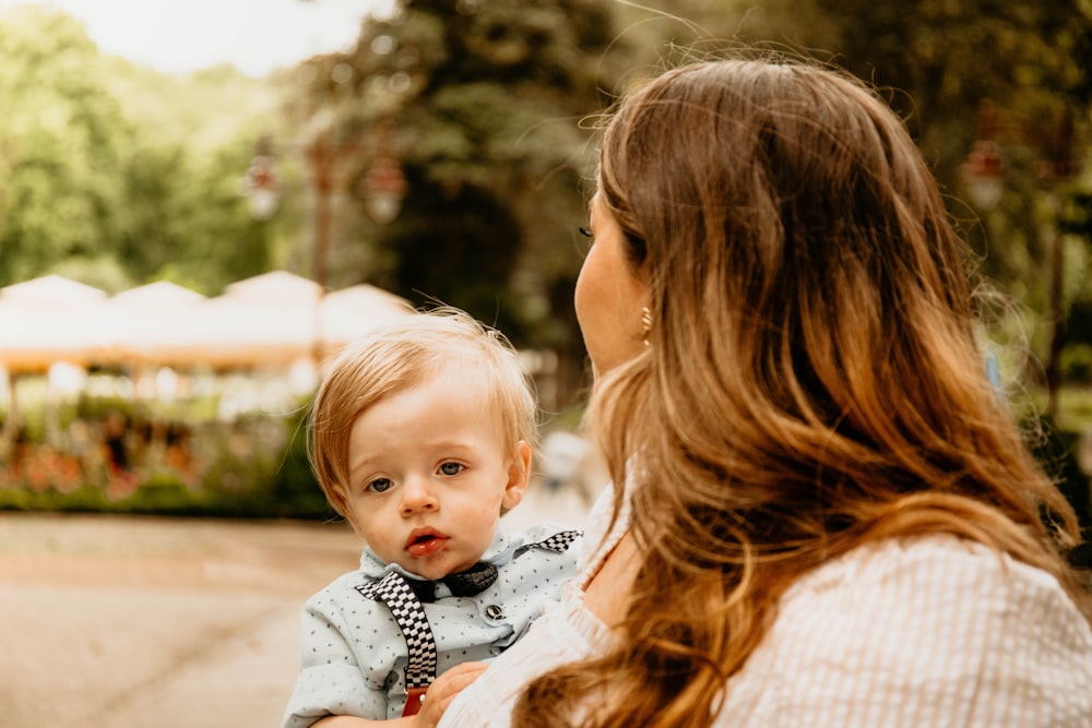 a woman holding a baby in her arms