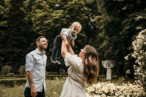 Photographer capturing a joyful family moment outdoors with natural light.