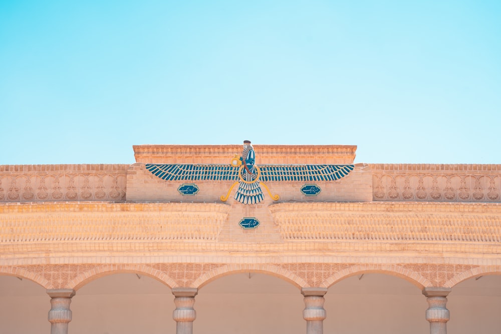 a blue bird statue on top of a building