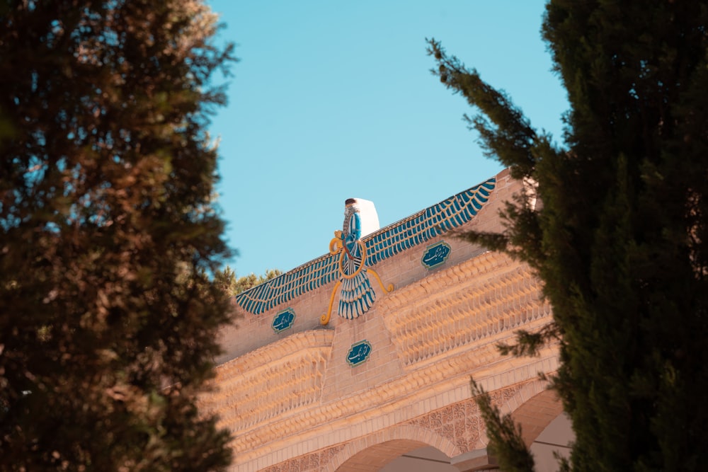 a statue of an egyptian man on top of a building