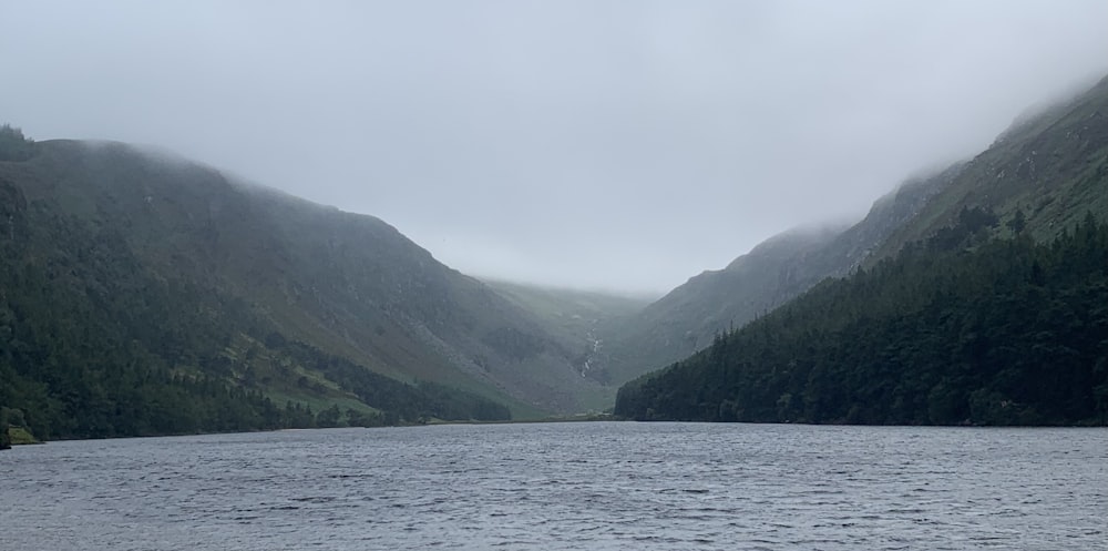 a body of water with mountains in the background