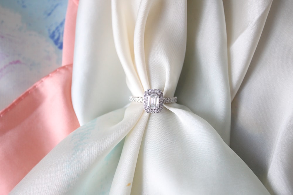 a close up of a white cloth with a ring on it