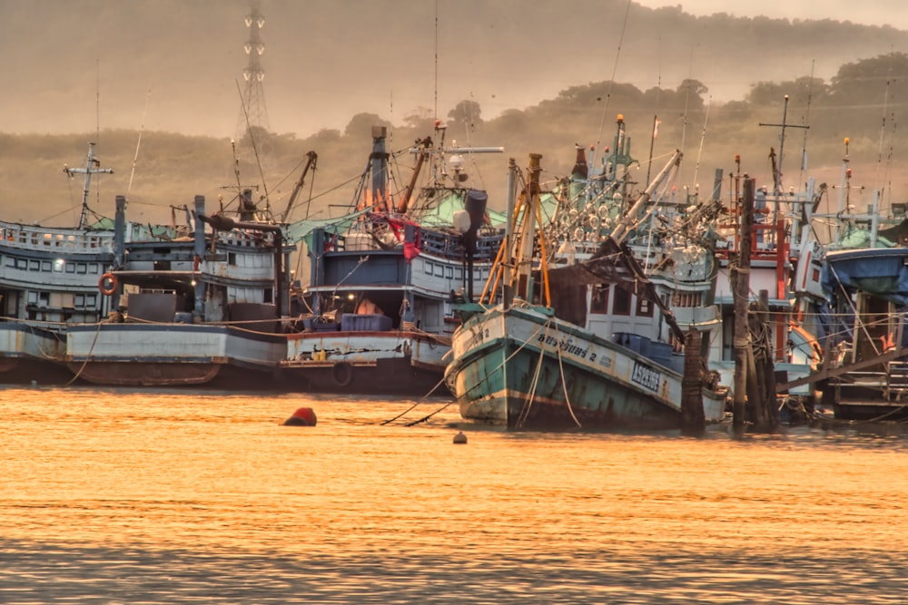 a boat is docked next to a body of water