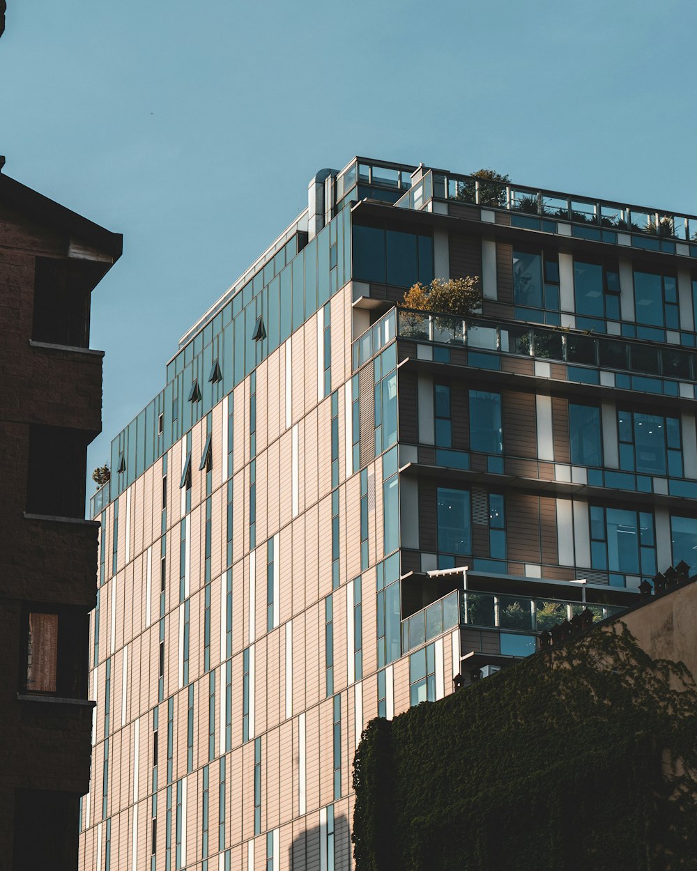 a tall building with lots of windows next to a tall building