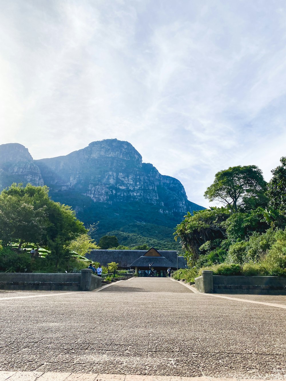 an empty parking lot with mountains in the background