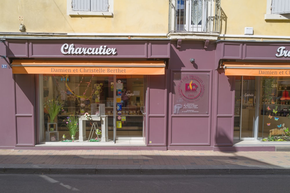 a store front with a purple and orange awning